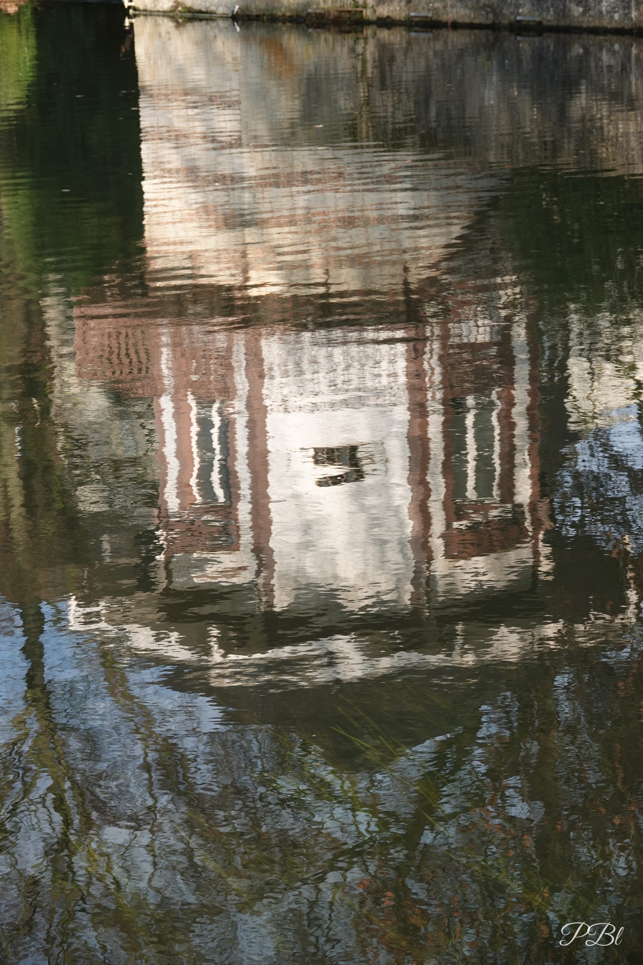 Reflet d'une maison ancienne dans l'eau d'une rivière